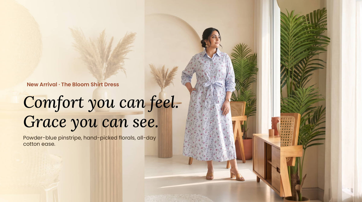 Woman wearing a powder-blue floral pinstripe shirt dress with a waist tie in a bright room.